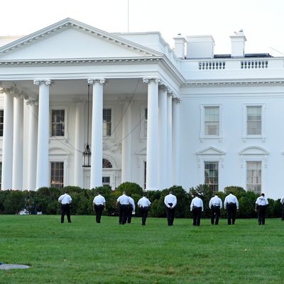 Uniformed Secret Service officers walk along the lawn on the North side of the White House in Washington, Saturday, Sept. 20, 2014. The Secret Service is coming under intense scrutiny after a man who hopped the White House fence made it all the way through the front door before being apprehended. (AP Photo/Susan Walsh)