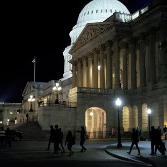 WASHINGTON, DC - MARCH 10: A group of visitors walks past the Senate carriage entrance as Senate Democrats speak nonstop on the chamber floor about climate change on March 10, 2014 in Washington, DC. The self-titled Climate Caucus, a group of 26 senators working with a parallel House caucus, plan to speak until the morning of March 11 in an effort to highlight the issue of global warming. (Photo by T.J. Kirkpatrick/Getty Images)