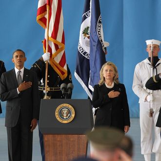 JOINT BASE ANDREWS, MD - SEPTEMBER 14: U.S. President Barack Obama (2nd L) and U.S. Secretary of State Hillary Clinton (3rd R) hold their hands over their hearts during the Transfer of Remains Ceremony for the return of Ambassador Christopher Stevens and three other Libyan embassy employees at Joint Base Andrews September 14. 2012 in Joint Base Andrews, Maryland. Stevens and the three other embassy employees were killed when the consulate in Libya was attacked September 11. (Photo by Molly Riley-Pool/Getty Images)