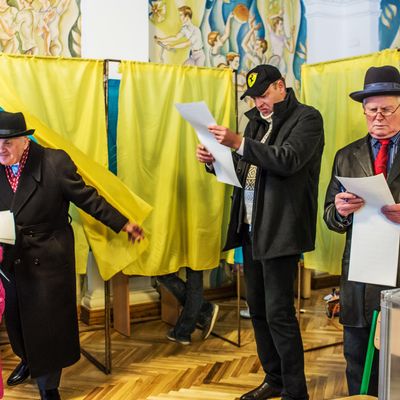 Voters review their ballots before casting their votes in parliamentary elections at a polling station on October 26, 2014 in Kiev, Ukraine. Although a low turnout is expected in the east of the country amid continued fighting between Ukrainian forces and pro-Russian separatists, Ukraine is expected to elect a pro-Western parliament in a further move away from Russian influence. 