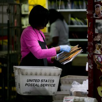 U.S. Postal Service employee Terrie Williams sort mail before delivery at the Brookland Post Office in Washington, D.C., U.S., on Thursday, May 9, 2013. The USPS is projecting a loss of as much as a $6 billion for the year as it keeps pressure on Congress for help, Postmaster General Patrick Donahoe said this month. The service is scheduled to release second-quarter results May 10. Photographer: Andrew Harrer/Bloomberg via Getty Images