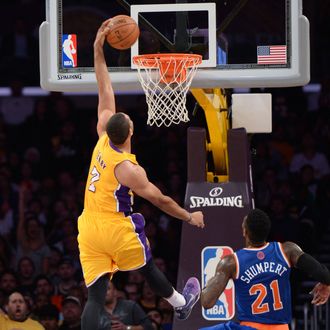Xavier Henry #7 of the Los Angeles Lakers attempts a dunk while being pursued by Iman Shumpert #21 of the New York Knicks at STAPLES Center on March 25, 2014 in Los Angeles, California.