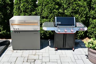 Two grills side by side. On the left, the $12,000 Zwilling Flammkraft Model D; on the right, the black-painted Weber Genesis EX-325W
