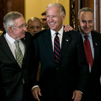 WASHINGTON, DC - JULY 25: U.S. Sen. Harry Reid (D-NV) (L) and U.S. Sen. Charles Schumer (D-NY) (R) leave the Senate chambers with U.S. Vice President Joe Biden to speak at a press conference following a 54-45 vote against a House bill that would include the wealthiest Americans in an extension of the Bush-era tax cuts on July 25, 2012 in Washington, DC. The Senate instead approved by a vote of 51-48 a Democratic bill that excludes the highest-earning Americans from a yearlong extension of tax cuts. (Photo by T.J. Kirkpatrick/Getty Images)