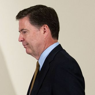 FBI Director James Comey walks to the podium to make a statement at FBI Headquarters in Washington, Tuesday, July 5, 2016. Comey said the FBI will not recommend criminal charges in its investigation into Hillary Clinton's use of a private email server while secretary of state. (AP Photo/Cliff Owen)