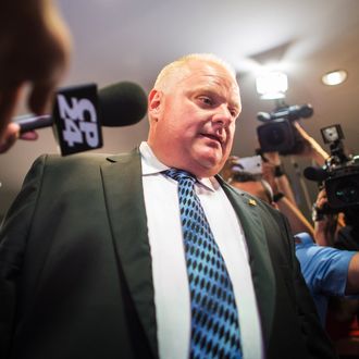 Toronto Mayor Rob Ford leaves his office at city hall in Toronto on June 30, 2014 amid a crush of cameras. The crack-smoking mayor Rob Ford returned to work more popular than ever after a stint in rehab for his internationally publicized alcohol and drug abuse. 