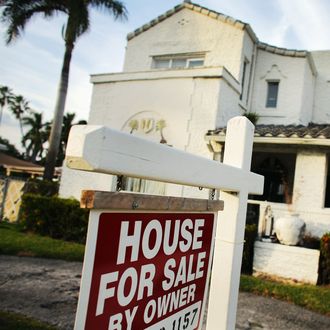 A 'For Sale' sign is posted in front of a house in Hollywood, Florida. 