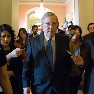 WASHINGTON, DC - DECEMBER 30: Senate Minority Leader Mitch McConnell (R-KY) walks with reporters on his way to a meeting with Republicans on Capitol Hill December 30, 2012 in Washington, DC. The House and Senate are both in session today to deal with the looming 'fiscal cliff.' issue. (Photo by Drew Angerer/Getty Images)