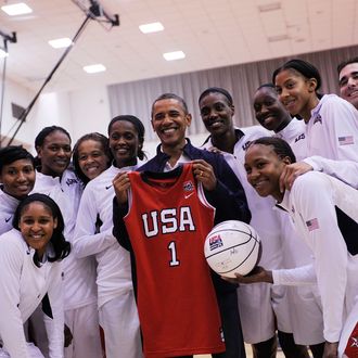 WASHINGTON, DC - JULY 16: U.S. President Barack Obama poses with the Olypmics-bound U.S. Women's National Basketball team after their victory over Brazil at the Verizon Center on July 16, 2012 in Washington, DC. (Photo by Leslie E. Kossoff-Pool/Getty Images)