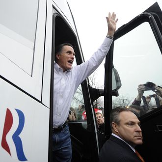 Republican presidential hopeful Mitt Romney waves getting on his campaign bus after paying a visit to Tommy's Country Ham House in Greenville, South Carolina, January 21, 2012. South Carolina holds its Republican primary on January 21, 2012.