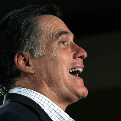 Republican presidential candidate and former Massachusetts governor Mitt Romney laughs during a spaghetti dinner at Tilton School on January 6, 2012.
