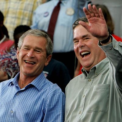 President Bush Campaigns In U.S. President George W. Bush (L) and his brother Florida Governor Jeb Bush (R) smile while greeting supporters during a campaign rally October 19, 2004 in St. Petersburg, Florida. 