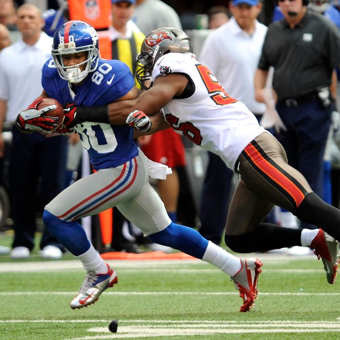 Giants' wide receiver Victor Cruz (80) is tackled by Buccaneer's linebacker Dekoda Watson (56) in the first half during NFL action between the New York Giants and the Tampa Bay Buccaneers at the MetLife Stadium in East Rutherford, New Jersey. The Giants defeated the Buccaneers 41-34.
