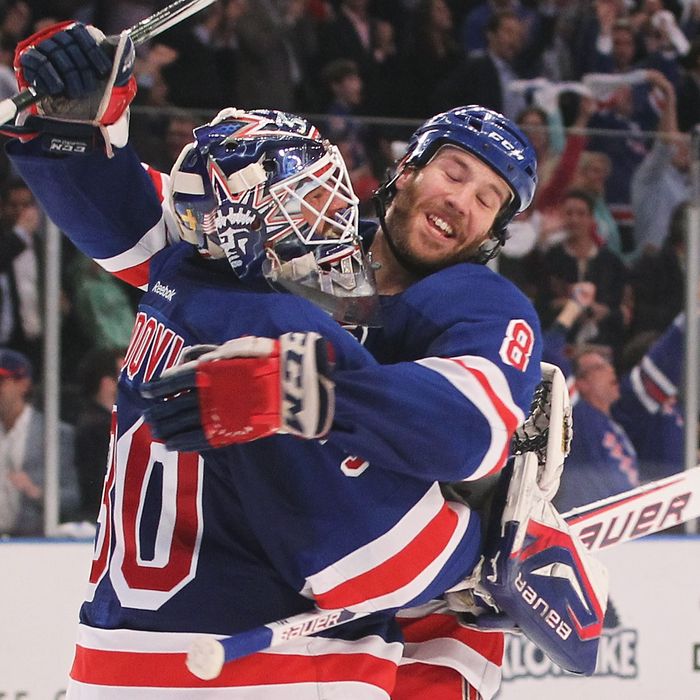 Henrik Lundqvist #30 and Brandon Prust #8 of the New York Rangers celebrate their 2 to 1 win over the Ottawa Senators in Game Seven of the Eastern Conference Quarterfinals during the 2012 NHL Stanley Cup Playoffs at Madison Square Garden on April 26, 2012 in New York City.