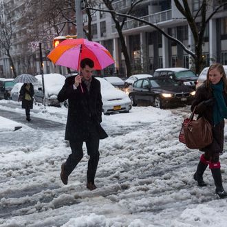 NEW YORK, NY - FEBRUARY 05: People attempt to walk across a snowy street during a snow storm on February 5, 2014 in the Greenwich Village neighborhood of New York, United States. New York and surrounding regions were hit with yet another snow storm today, bringing snow and ice over night, and sleet and freezing rain during theday. (Photo by Andrew Burton/Getty Images)