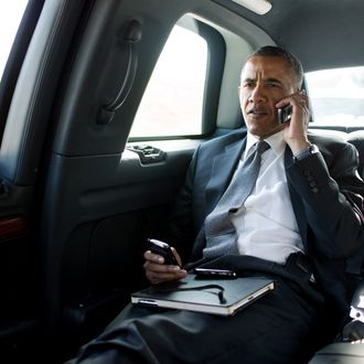 PALM BEACH, FL - JULY 20: In this handout provided by The White House, President Barack Obama talks on the phone with Aurora Mayor Steve Hogan during the motorcade ride to Palm Beach International Airport July 20, 2012 in Palm Beach, Florida.. The President called Mayor Hogan to offer his condolences and support to the Aurora community. (Photo by Pete Souza/The White House via Getty Images)