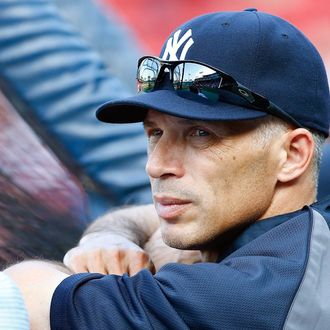 Manager Joe Girardi #29 of the New York Yankees watches his team hit during batting practice prior to the game against the Boston Red Sox on July 6, 2012 at Fenway Park in Boston, Massachusetts. 
