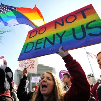 Same-sex marriage supporters shout slogans in front of the US Supreme Court on March 26, 2013 in Washington, DC. The US Supreme Court on Tuesday takes up the emotionally charged issue of gay marriage as it considers arguments that it should make history and extend equal rights to same-sex couples. Waving US and rainbow flags, hundreds of gay marriage supporters braved the cold to rally outside the court along with a smaller group of opponents, some pushing strollers. Some slept outside in hopes of witnessing the historic hearing.