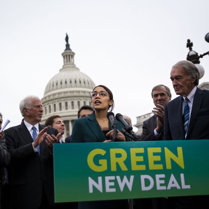 Representative Alexandria Ocasio-Cortez, a Democrat from New York, speaks as Senator Ed Markey, a Democrat from Massachusetts, right, listens during a news conference announcing Green New Deal legislation in Washington, D.C., U.S., on Thursday, Feb. 7, 2019.