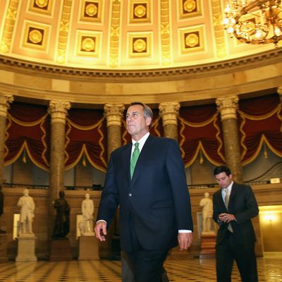 Speaker of the House John Boehner (R-OH) (C) walks through Statuary Hall before entering the House Chamber to oversee a vote on 