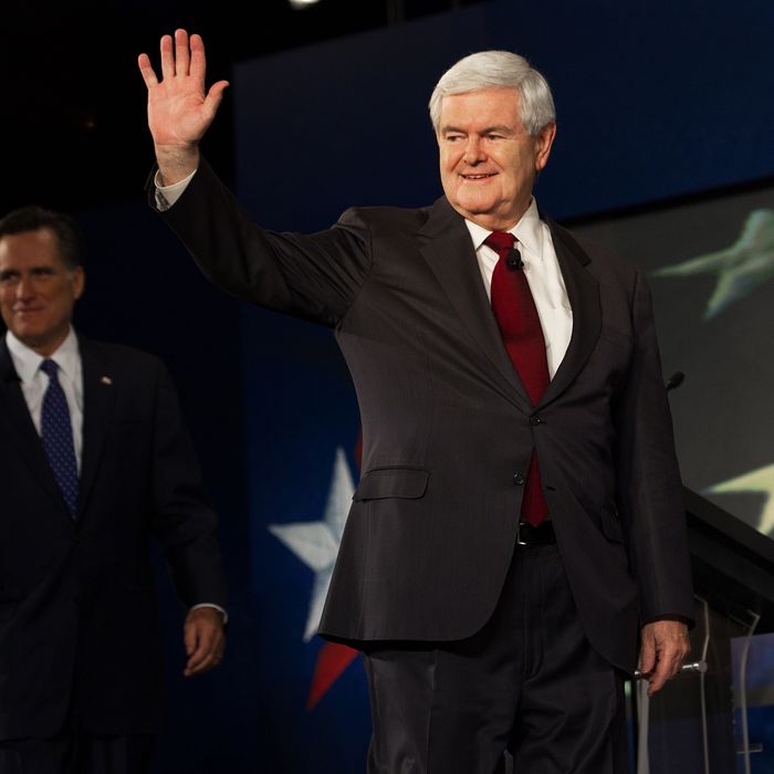 Republician presidential hopeful Newt Gingrich waves, followed by Mitt Romney, as they arrive to participate in the South Carolina Presidential Debate at Wofford College, sponsored by SCGOP, CBS News and the National Journal on November 12, 2011 in Spartanburg, South Carolina. AFP PHOTO/Paul J. Richards (Photo credit should read PAUL J. RICHARDS/AFP/Getty Images)