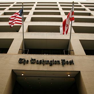 Flags wave in front of the Washington Post building on May 1, 2009 in Washington, DC. The newspaper has announced its first quarter earnings with a net loss of $19.5 million.
