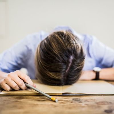 Woman with her head on her desk.