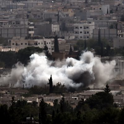 Smoke from shelling rises in the Syrian town of Ain al-Arab, known as Kobane by the Kurds, as it seen from the Turkish - Syrian border in the southeastern village of Mursitpinar, Sanliurfa province, on October 13, 2014.