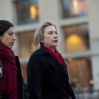 US Secretary of State Hillary Clinton (C) arrives for a NATO Foreign Minister family photo in front of the Brandenburg Gate in Berlin April 14, 2011. NATO Thursday urged Moamer Kadhafi to step down and vowed to keep hitting his forces as long as it takes, but the alliance failed to secure firm pledges for new planes it said were needed to finish the job. AFP PHOTO / POOL/ SAUL LOEB (Photo credit should read SAUL LOEB/AFP/Getty Images)