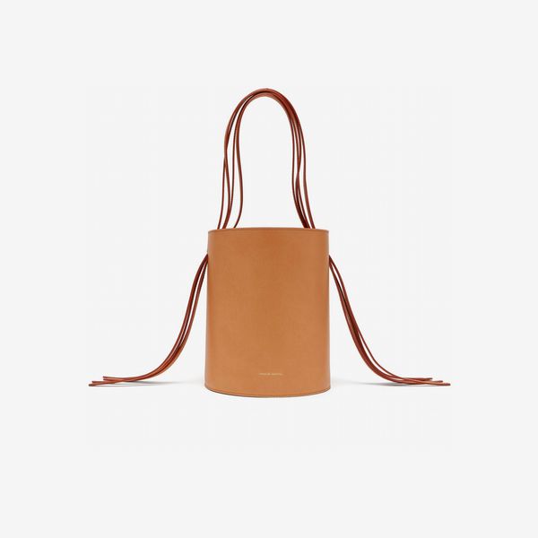 Mansur Gavriel Fringe Pink-Lined Leather Bucket Bag a matte finish tan leather bucket bag with a fringed handle and pink lining. The Strategist - 48 Things on Sale You’ll Actually Want to Buy: From Sunday Riley to Patagonia