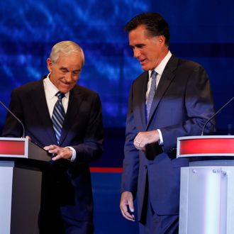 AMES, IA - AUGUST 11: Republican presidential candidates former Massachusetts Gov. Mitt Romney and Rep. Ron Paul, R-Texas talk during a commercial break at the Iowa GOP/Fox News Debate on August 11, 2011 at the CY Stephens Auditorium in Ames, Iowa. This is the first Republican presidential debate in the state ahead of Saturday's all important Iowa Straw Poll. (Charlie Neibergall-Pool/Getty Images)