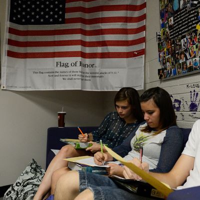 WHEAT RIDGE, CO. - SEPTEMBER 25: Wheat Ridge High School students from left to right, Jana McVey, 15, Michaela Zavala, 14, and Chay Martin, 15, work on classwork in Stephanie Rossi's sophomore AP U.S. History class Thursday afternoon, September 25, 2014. Their teacher, Stephanie Rossi, is against the Jefferson County School board member's proposal to change the AP U.S. History curriculum which includes promoting patriotic material, respect for authority and the free-market system and avoiding material about civil disorder, social stripe and disregard for the law. (Photo By Andy Cross / The Denver Post)