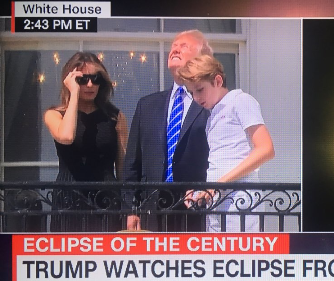 President Donald Trump stares into the solar eclipse and points up on August 21, 2017.