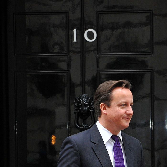 British Prime Minister David Cameron is pictured at the front door of 10 Downing Street in London, on November 16, 2011, as he awaits the arrival of Serbian President Boris Tadic. The Bank of England on Wednesday cut its forecasts for British economic growth, saying the 