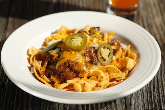 Frito Pie: Fritos topped with Texas red chili, cheese, onions and pickled jalapeños.