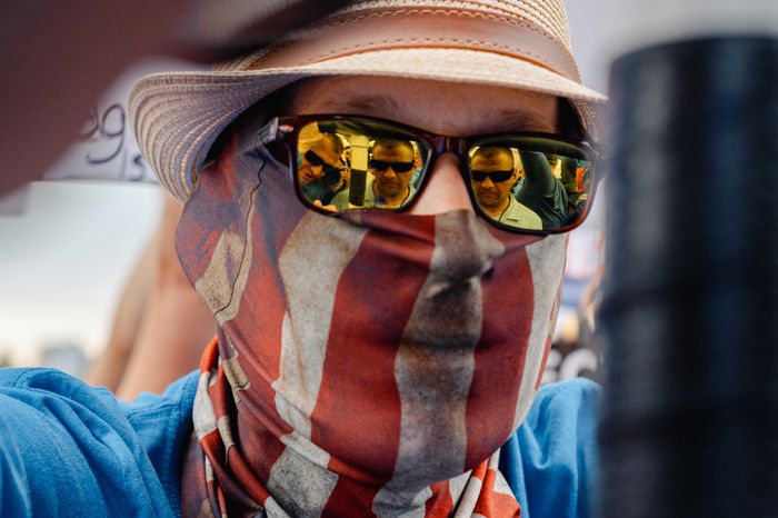 A man wears an American flag bandanna over his face at the second March for our Lives rally.