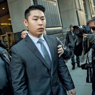 New York City Police (NYPD) officer Peter Liang (C) departs the criminal court after an arraignment hearing in the Brooklyn borough of New York City February 11, 2015. The New York City rookie police officer was charged with manslaughter in the second degree and five other offenses on Wednesday for the fatal shooting of an unarmed man in the darkened stairwell of a housing project last November. REUTERS/Brendan MCDermid (UNITED STATES - Tags: CRIME LAW) - RTR4P81A