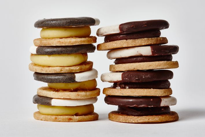 Eleven Madison Park's "black and whites" are actually Cheddar shortbread with white-butter and black-vegetable-ash glazes (at left), and oatmeal shortbread with apple filling and chocolate glaze.