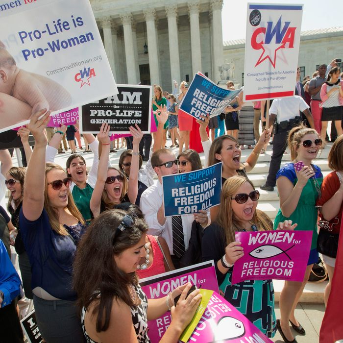 Demonstrator react to hearing the Supreme Court's decision on the Hobby Lobby case outside the Supreme Court in Washington, Monday, June 30, 2014. The Supreme Court says corporations can hold religious objections that allow them to opt out of the new health law requirement that they cover contraceptives for women.(AP Photo/Pablo Martinez Monsivais)