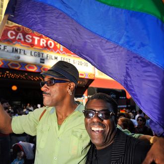 Troy Brunet (L) waves a flag as celebrations ensue in the Castro neighborhood of San Francisco, California, June 26, 2012, after the US Supreme Court struck down The Defense of Marriage Act (DOMA), and declared that same-sex couples who are legally married deserve equal rights to the benefits under federal law that go to all other married couples. In another ruling, the Supreme Court cleared the way for same-sex marriages to resume in California as the justices, in a procedural ruling, turned away the defenders of Proposition 8.