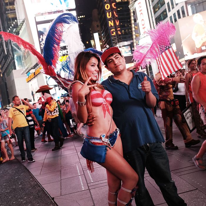 Spotlight On Times Square As Painted-Topless Women Draw Ire Of Mayor And Governor