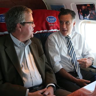 IN FLIGHT - OCTOBER 31: Republican presidential candidate, former Massachusetts Gov. Mitt Romney (R) talks with former Florida Gov. Jeb Bush aboard his campaign plane on October 31, 2012 en route to Miami, Florida. With less than one week to go until election day, Mitt Romney is campaigning throughout Florida. (Photo by Justin Sullivan/Getty Images)