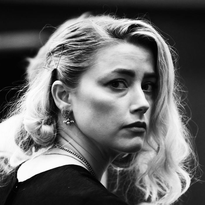 Amber Heard looks over her shoulder at her defamation trial.