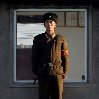 A North Korea soldier stands guard on the banks of the Yalu River which separates the North Korean town of Sinuiju from the Chinese border town of Dandong on the second anniversary of the death of former leader Kim Jong-Il, December 17, 2013. North Korean leader Kim Jong-Un presided over a major remembrance ceremony on the second anniversary of the death of his father and former leader Kim Jong-Il. The meeting came days after the shock execution of Kim Jong-Un's uncle and one-time political mentor, Jang Song-Thaek -- a purge that raised questions about the stability of the current regime in Pyongyang. 