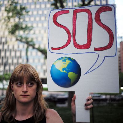 A woman displays a placard during a demonstration in New York on June 1, 2017, to protest US President Donald Trump's decision to pull out of the Paris climate accord deal.