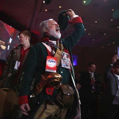 William Temple of the Golden Isles Tea Party in Georgia, dressed as Button Gwinnett, the second signer on the United States Declaration of Independence, cheers as Ben Carson speaks during the 42nd annual Conservative Political Action Conference (CPAC) February 26, 2015 in National Harbor, Maryland.