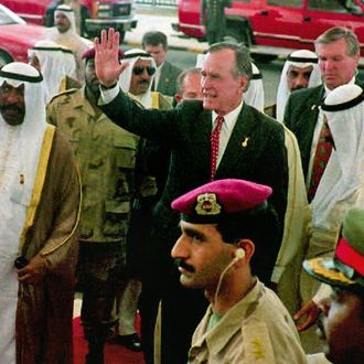 KUWAIT, KUWAIT - APRIL 15: Former U.S. President George Bush (center-R) waves on his way to attend a special session in the Kuwaiti Parliament 15 April 1993. At (L) in the foreground is Kuwait Prime Minister Saad al Abdalla. (Photo credit should read RAED QUTANIA/AFP/Getty Images)