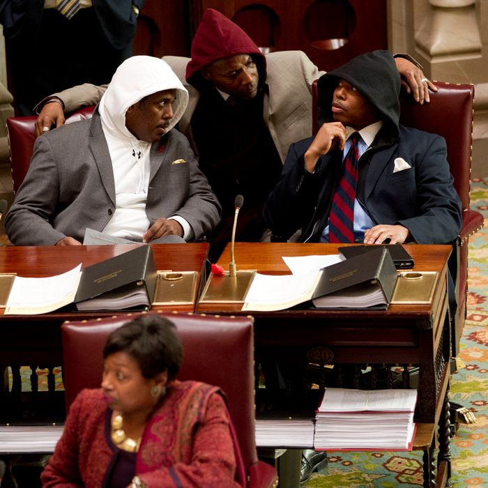 Sen. Kevin Parker, D-Brooklyn, left, Sen. Bill Perkins, D-New York, center, and Sen. Eric Adams, D-Brooklyn, wear hooded sweatshirts during session in the Senate Chamber in Albany, N.Y., on Monday, March 26, 2012. The senators wore the sweatshirts to protest the shooting death of Florida teen Trayvon Martin by a neighborhood watch volunteer.