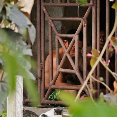 Thai and Burmese fishermen, held in a cage so they can't run away.