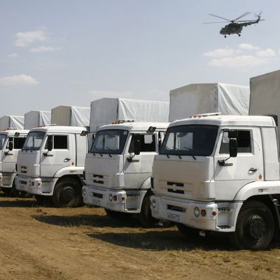 Trucks from a Russian humanitarian convoy are parked on a field outside the town of Kamensk-Shakhtinsky in the Rostov region, some 30kms from the Russian-Ukrainian border, Russia, on August 14, 2014. A massive Russian 